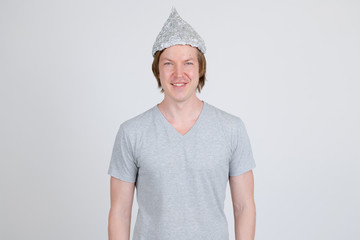 Young man wearing tin foil hat as conspiracy theory concept