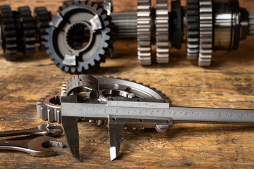 motorcycle gearbox/transmission on a workbench with precision measuring tools