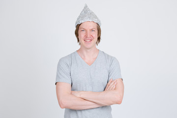 Happy young man with tinfoil hat as conspiracy theory concept