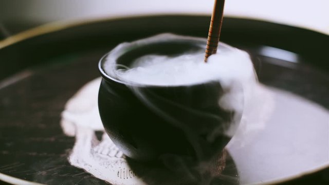 Witch's Cauldron bubbling with green potion in a spooky halloween scene. Dry ice was used for the practical effect.
