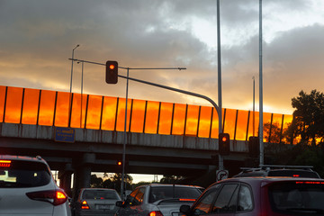Traffic jam below interstate highway during golden hour.