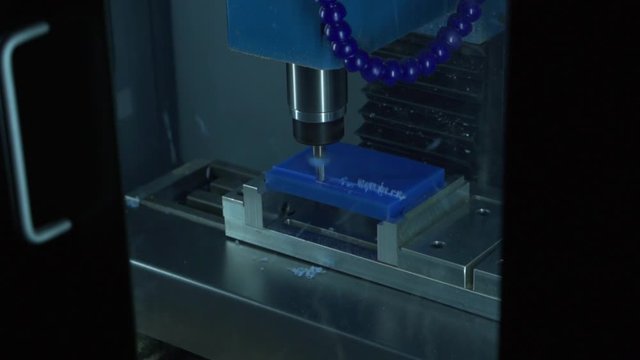 3 axis desktop CNC mill face cutting blue plastic stock with end mill tool time lapse 15 seconds