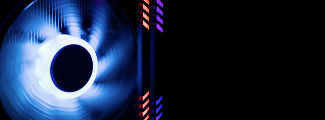 Banner. Inside a high performance computer. Cooler of processor with neon blue light.  RAM glows red  and purple