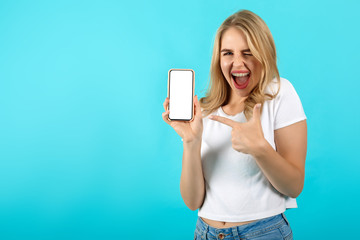 Cheerful lady holding in hands new cool device and pointing to it