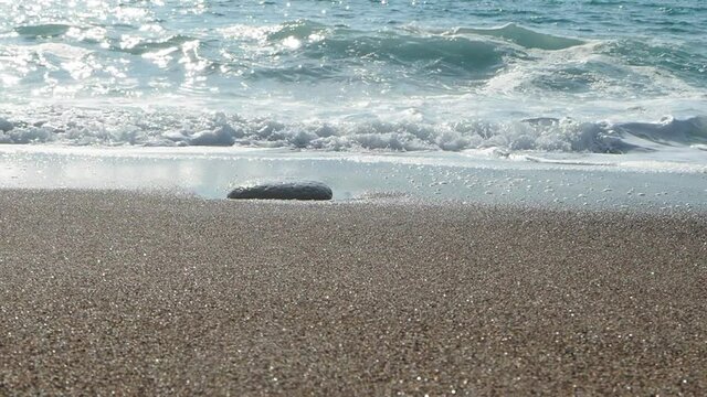 Waves crashing on a beach in Cyprus. Rock, stone, sand in a sunny. Mediterranean sea. Cyprus. 