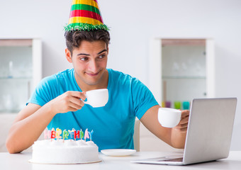 Young man celebrating birthday alone at home