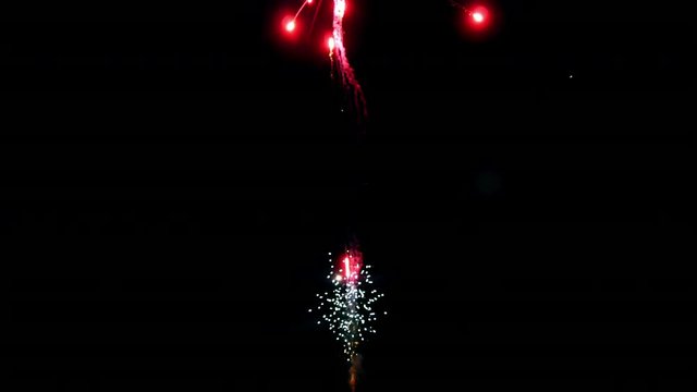 Red firework element on black background night to create video about salute on holiday and pyrotechnics happy New Year, Christmas, birthday greetings.