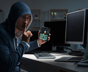 Hacker hacking computer at night