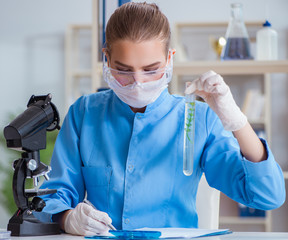 Female scientist researcher conducting an experiment in a labora