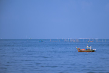 Fototapeta na wymiar Fishing boats on the sea with blue sky background.Bang Saen Beach,Chonburi district,Thailand. 