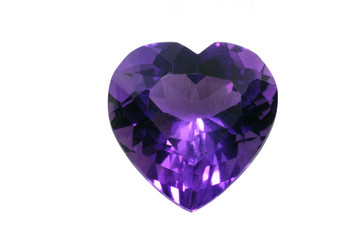 Amethyst ruby in the shape of heart isolated on white background. Purple shiny gem. 