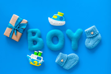 Boy's birthday concept. Set in blue colors with gift box on blue backgound top view