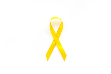 Disease control concept. Yellow ribbon on white background top view copy space