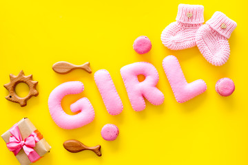 Girls's birthday concept. Pink baby set with gift box on yellow backgound top view