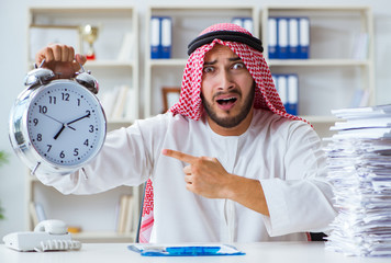 Arab businessman working in the office doing paperwork with a pi
