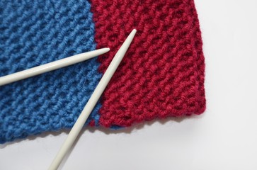 The needles are on the table and on the knitted fabric in the insulator.