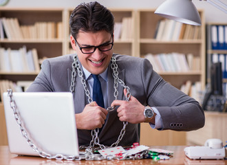 Young businessman addicted to online gambling cards playing in t