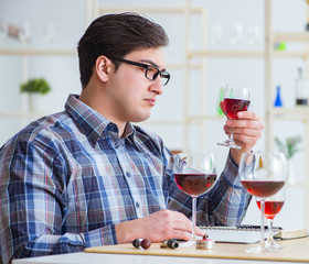 Professional sommelier tasting red wine
