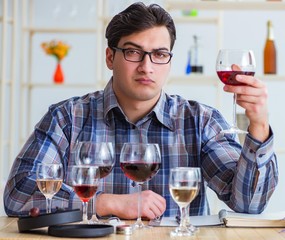 Professional sommelier tasting red wine
