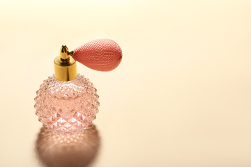Elegant vintage bottle of perfume on beige background, space for text