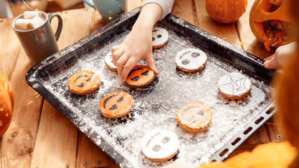 Young adult mother holding cookies biscuit on tray pan