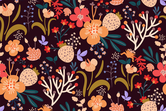 Seamless floral pattern in bright warm colors on dark background. Botanical print of various flowers, berries, leaves. Hand drawn vector illustration.