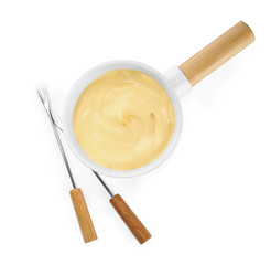 Pot of tasty cheese fondue and forks isolated on white, top view