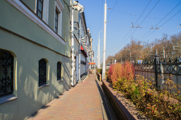 Fototapeta premium City street with old architecture near the road.
