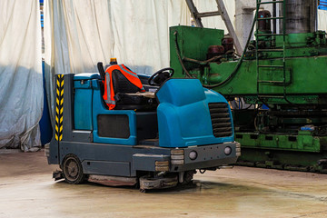 Floor sweeper and washer scrubber drier car in an industrial building engineering workshop