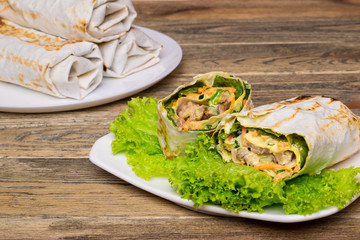 Thin pita bread filling with pork and vegetables. Homemade lavash roll on