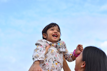 Obraz premium Little Child Girl on The Blue Sky