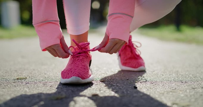 Handheld view of woman&rsquo;s legs during jogging