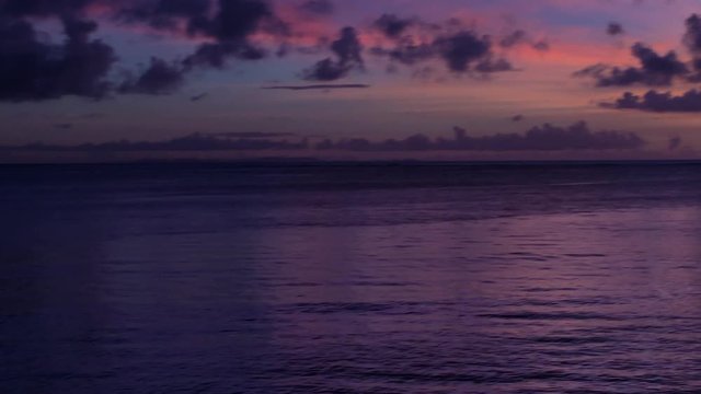 Dramatic Purple Sunset with Silhouette of fisherman in Lagoon. Chatan, Okinawa, Japan.