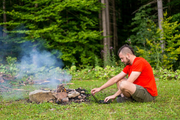 Remote work concept: a man working on a laptop outdoors. Work during the holidays, workaholic. Freelance