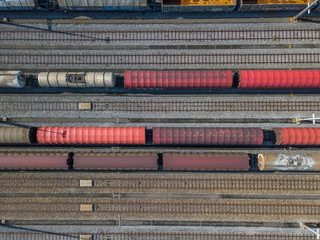 Aerial view of freight train wagons on large railway track field. Concept of modern logistics.