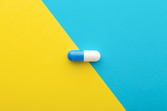 Pharmaceutical Pill On Yellow Blue Background