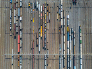 Aerial view of freight train wagons on large railway track field. Concept of modern logistics.