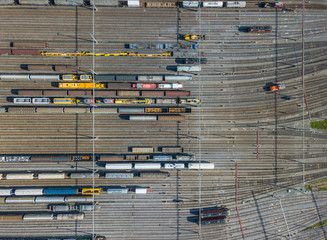 Aerial view of freight train wagons on large railway track field. Concept of modern logistics.
