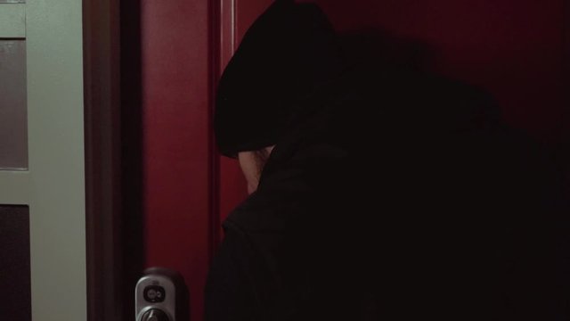 Young man thief breaks into luxury apartment after picking the lock