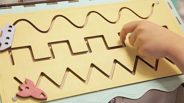 A child plays a developmental game. Puzzle game for the development of children