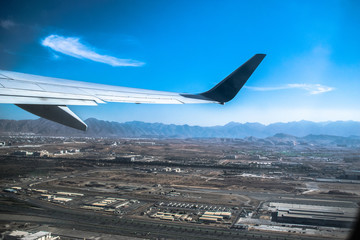 wing of an airplane flying above the clouds