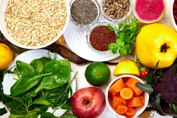 Set of organic healthy diet food, superfoods - beans, legumes, nuts, seeds, greens, fruit and vegetables on white background, copy space. Top view, frame, flat lay..