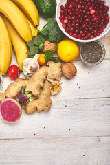 Products rich in antioxidants and vitamins, mineral on white wooden background, Healthy diet, vegan food.  Top view, flat lay, copy space..