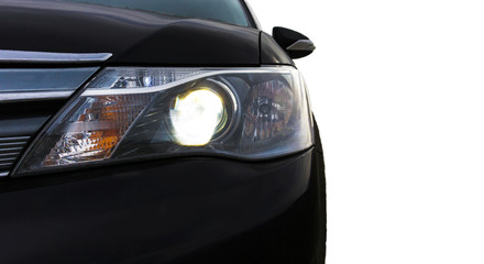 Headlight. Black car on a white isolated background.