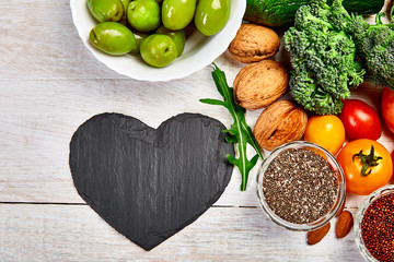 Background healthy food for heart. Healthy food, diet and life. Fresh fruits and vegetables, berries and nuts. Healthy heart concept. Top view, flat lay, Copy space.