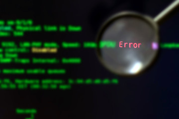 The magnifier is on a black background with green blurred text, selective focus. Software testing. The concept of finding errors in computer programs
