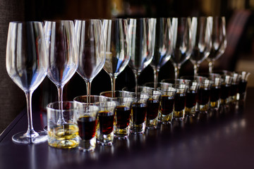 Rows of glasses with alcohol on degustation 