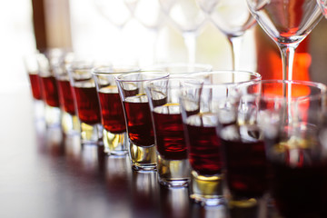 Rows of glasses with alcohol on degustation 
