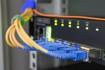 The modules for high-speed server interface are close-ups. Technological concept of data transfer. Fiber optic internet wires are connected to the ports of an access network switch