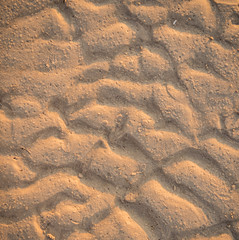 Ripples in wet sand background texture. Beach sand background